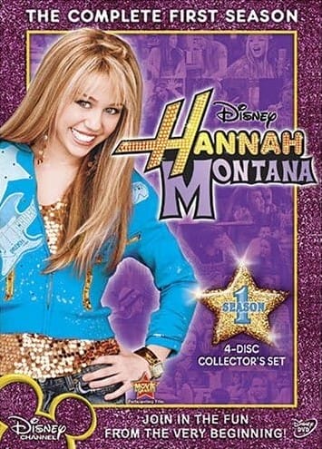 The poster for 'Hannah Montana season 1' boxset. Hannah is standing on the right side of it, smiling at the viewer and wearing a vibrant light-blue jacket with a pastel-blue guitar going across it and a matching star shape on her right shoulder. Underneath she's wearing a top made of golden sequins. Her jeans are dark-blue- She's wearing golden earrings to match her top, as well as a golden bangle bracelet. To the right of Hannah is the Hannah Montana logo with the small Disney logo above, shown in black. Both logos have a thin white outer glow on them, and so does as the image of Hannah. Underneath the logos is a golden star shape with a pale-blue number 1 and the word 'SEASON' written across it in the same colour. Both the number and the word are embossed to look 3D so they are distinguishable form each other. Underneath the star is written '4 DISC COLLECTOR'S SET' in a white sans-serif font. The poster has a background filled with dark-purple glitter. At it's top center it's written 'THE COMPLETE FIRST SEASON' in a white sans-serif font, while on the center bottom it says 'JOIN THE FUN FROM THE VERY BEGINNING' in the same font. At the bottom-left of the poster us the Disney Channel logo filled with the same dark-purple glitter and gold outline. On the bottom-right is a Disney DVD logo in white. At the center of the poster, behind all other elements, covering most of the background, is a large collage showing various scenes from the season with a semi-transparent purple color overlay and a goldem border.
